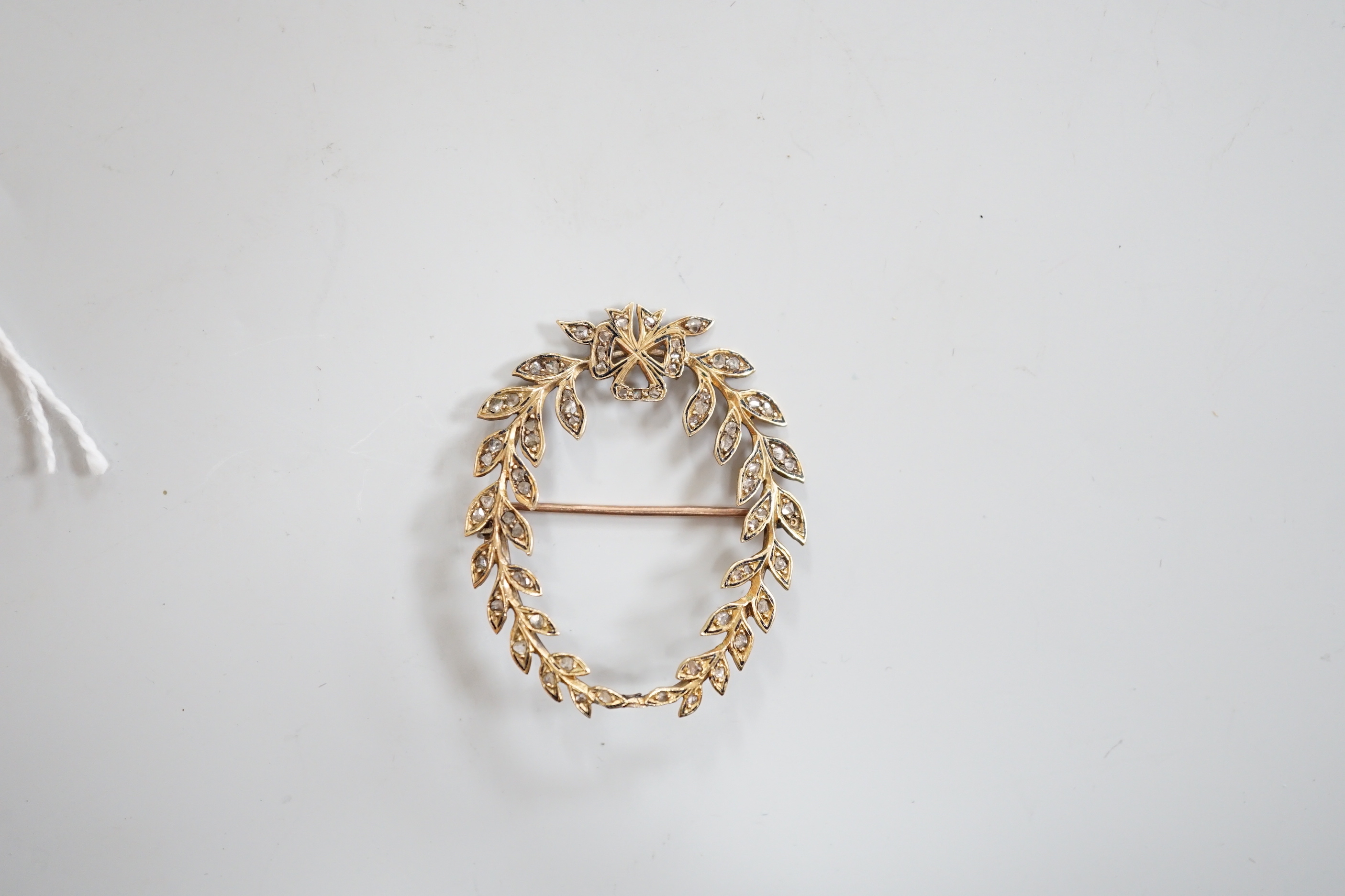 An early 20th century yellow metal and rose cut diamond set oval open work wreath brooch, 40mm, gross weight 5.1 grams.